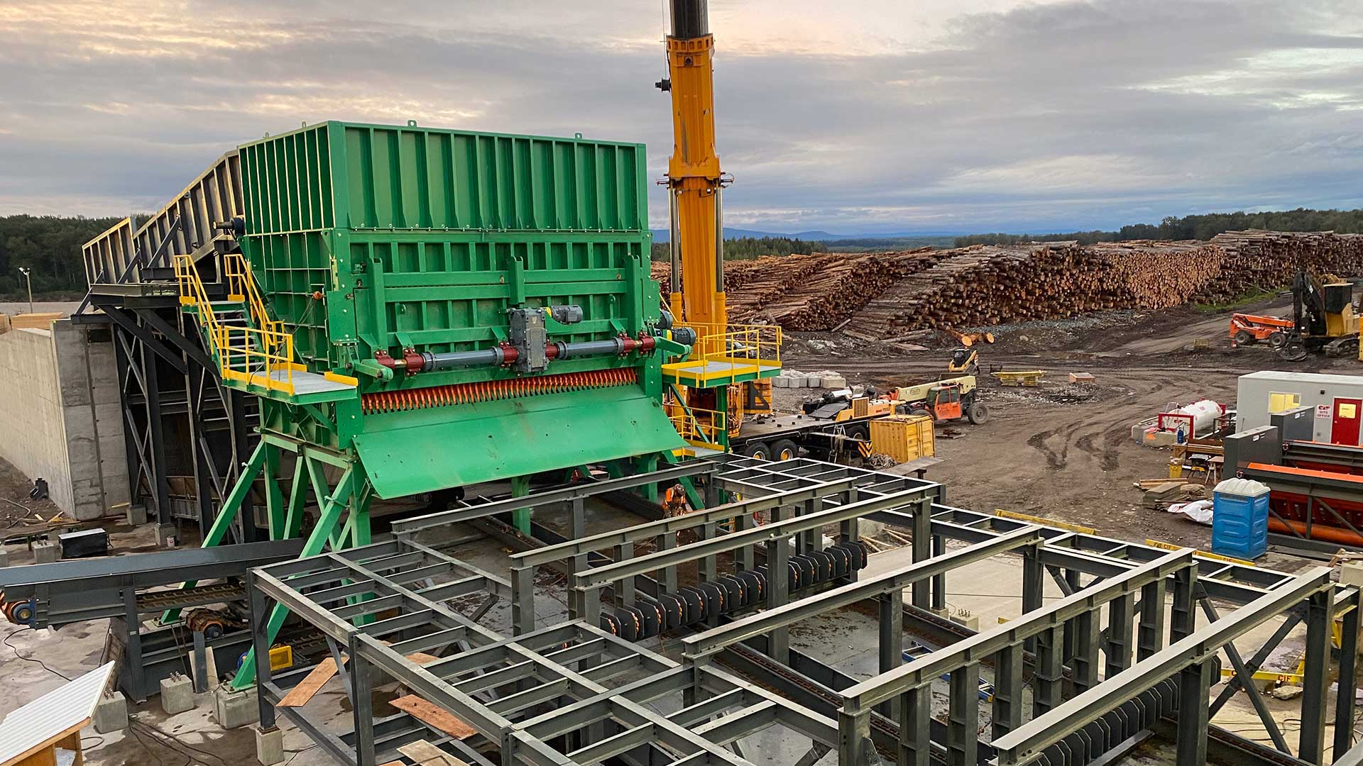 Wood chipping plant with lumber in the background